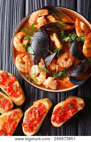 Delicious Tomato Soup Bouillabaisse With Shrimps, Fish Fillets And Mussels Closeup In A Bowl. Vertic