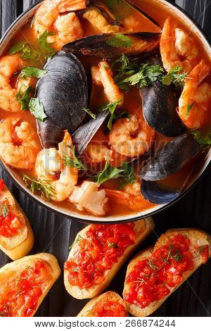 French Bouillabaisse Fish Soup With Shrimps, Fish Fillets And Mussels Closeup In A Bowl. Vertical To