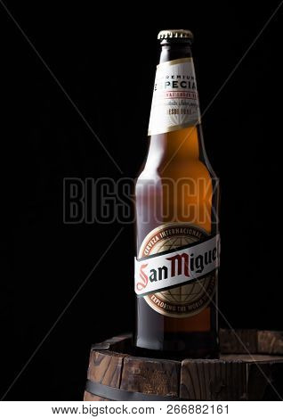 London, Uk - April 27, 2018: Bottle Of San Miguel Lager Beer On Top Of Old Wooden Barrel. The San Mi
