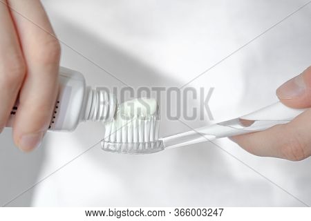 Close-up Toothbrush And Toothpaste In Hands, Hands Squeeze Paste From A Tube Onto A Toothbrush, Morn