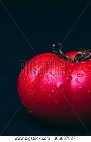 Fresh Red Tomato, Freshly Picked From The Bush, With Black Background