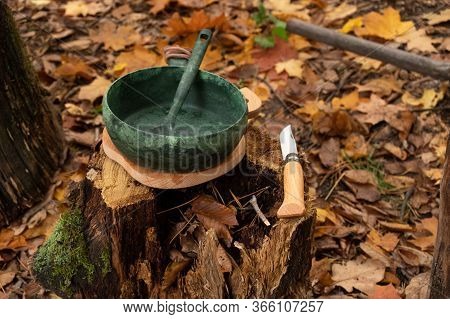 Angle View Of Dishes And A Knife. Utensils And Appliances In Nature.