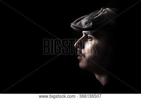 Portrait Of Cute Young Guy With Moustache And A Hat On Black, Dark Background. Copy Space, Space For