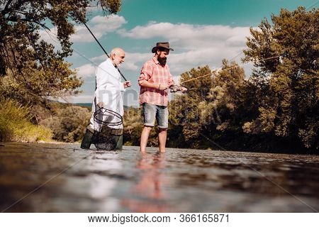 Elegant Bearded Man And Brutal Hipster Fishing. Hobby Sport Activity. Master Baiter. Father And Adul
