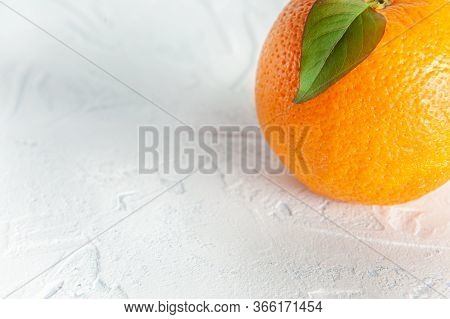 Orange On A White Background With A Leaf