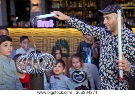 Electric Show, The Coil Electric . Holds A Led Lamp In His Hand, And Watches The Electrostatic Disch
