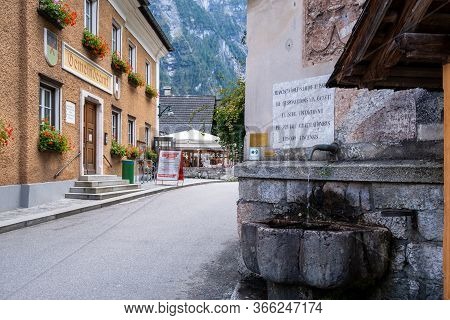 Hallstatt, Austria - October 6, 2019: View Of The Ancient Natural Drinking Water Station With The Vi