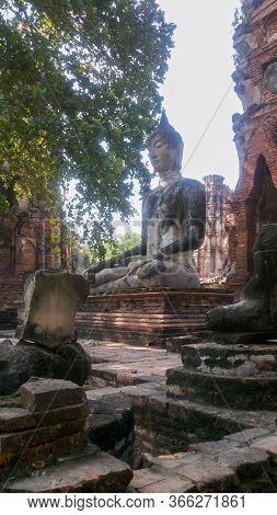 Seated Buddha And Sun Rays In Aytthaya, Thailand In Beautiful Summer Day