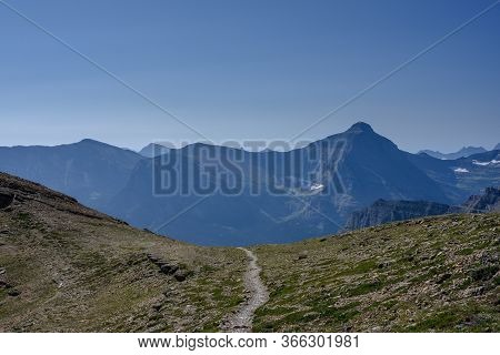 Trail Heads Down Over Mountain From Siyeh Pass In Montana Mountains