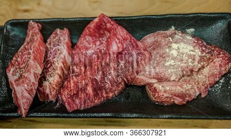 Thinly Sliced Japanese Wagyu Beef On Grille For Barbecue. Yakiniku Style