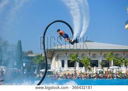 Antalya Turkey 27 Sept 2019: Man In Wetsuit On Flyboard Fly In Pool Hotel On Air Jet Or Water Pressu