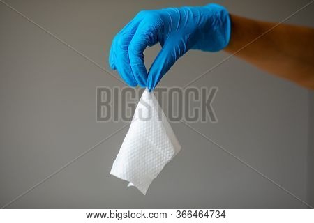 Wet Wipes Should be Thrown in the Trash - not in the sawer. Hand in blue protective glove