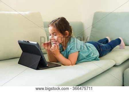 Child With Her Grandparents Video Chat. Happy Little Preschool Girl Is Studying Connected In Streami