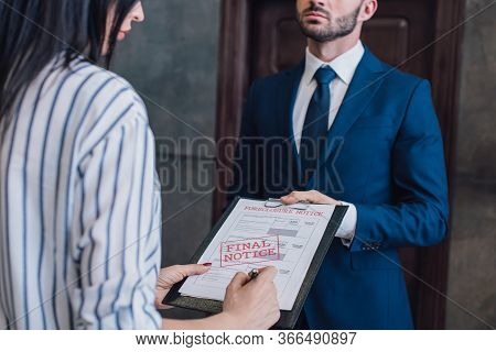 Cropped View Of Woman Writing In Documents With Foreclosure And Final Notice Lettering Near Collecto