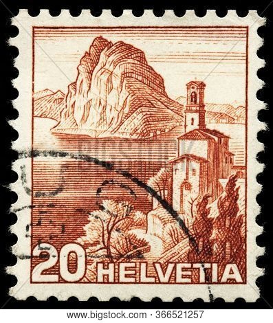 Luga, Russia - October 25, 2019: A Stamp Printed By Switzerland Shows Castagnola Church Against View