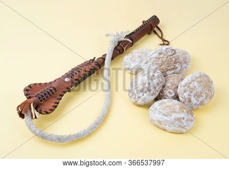 Whip And Gingerbread On A Neutral Background. Threats And Promises Concept. Encouragement And Punish