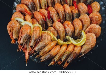 Shrimps With Lemon And Black Pepper On Dark Background Top View