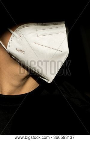 Young woman wearing KN-95 protection medical mask. Prevention of the spread of virus and epidemic, p
