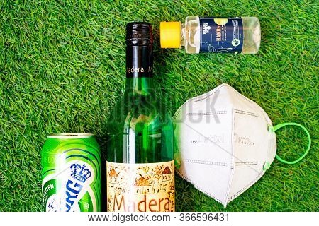 Flatlay Of Alcohol Liquor Bottles On Grass With A Mask And Sanitizer Showing The Home Delivery And P