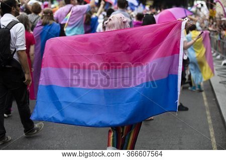 London, Uk - July 6th 2019: A Person Hods A Bisexual Pride Flag At A Gay Pride March In London