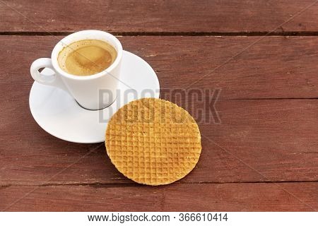 Cup Of Coffee And Hohey Wafer On Wooden Background.