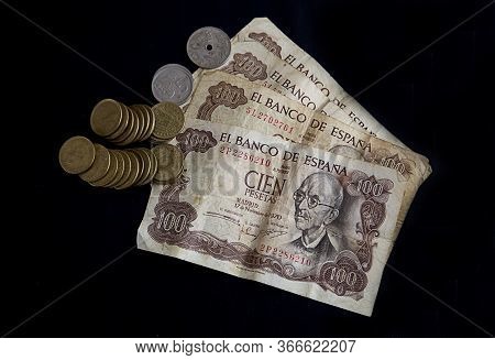 Banknotes And Pesetas Coins On Black Background