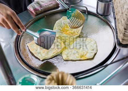 Roti Making, Roti Thresh Flour By Roti Maker With Oil. Indian Traditional Street Food. Thai Pancake 