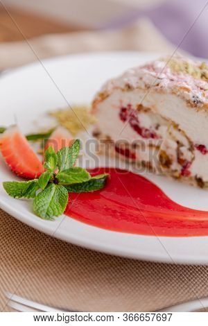 Beautiful Tasty Green Vegan Dessert Pistachio Strawberry Rolls On A Wooden Table In The Interior.
