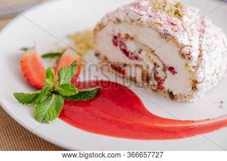Beautiful Tasty Green Vegan Dessert Pistachio Strawberry Rolls On A Wooden Table In The Interior.