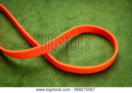 resistance exercise band for fitness and rehabilitation against green background