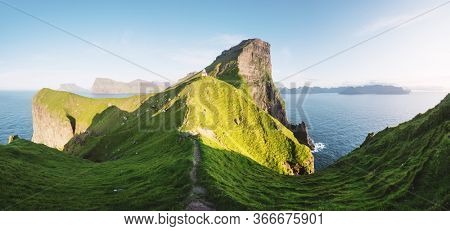 Panorama of green faroese hills and Kallur lighthouse on Kalsoy island, Faroe islands, Denmark. Landscape photography