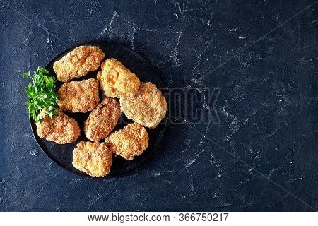 Japanese Pork Cutlets, Hirekatsu On A Black Plate On A Concrete Table, Horizontal View From Above, F