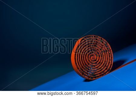 Round Orange-coloured Strip-type Massage Rugs Loom Down The Blue Cover On A Blue Background. Adverti