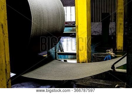 Close Up Of A Roll Of Rubber On A Machine In A Conveyor Belt Factory