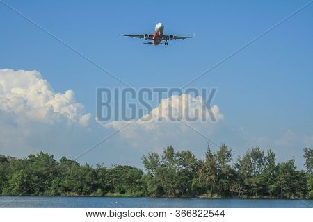 Rayong/thailand- ‎november ‎21, ‎2018: Blurred Photography Of Air Asia Airline Flying Over The Tree 