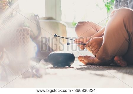 Young Woman Is Playing On Glucophone At Home. Close Up. Sits On The Floor At Home.