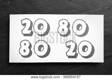 Sheet Of Paper With Numbers 20 And 80 On Black Slate Background, Top View. Pareto Principle Concept