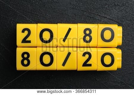 Yellow Blocks With Numbers 20 And 80 On Black Stone Background, Flat Lay. Pareto Principle Concept