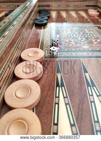 Backgammon With Wooden Inlay. Wooden Backgammon Board Game Of Pearl Inlaid On Brown Background.
