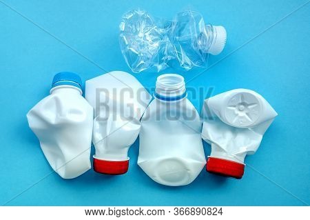 White Plastic Bottle On A Solid Blue Background For Recycle Waste. Waste Separation Concept. Protect