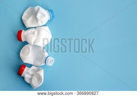 White Plastic Bottle On A Solid Blue Background For Recycle Waste. Waste Separation Concept. Protect