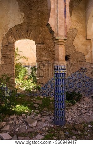 Yard Of A Ruin Of An Abandoned Building. Decorative Columns With Traditional Painted Tiles With Geom
