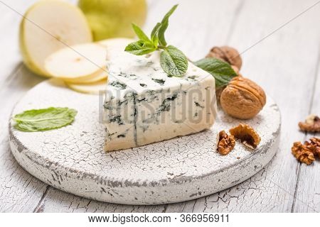 Segment Of Blue Mould Cheese - Gorgonzola With Pear And Walnuts On Wooden Board.  Top View Gorgonzol