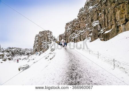 Silfra, Iceland-Feb 19, 2020: Toursts on Silfra rift during winter, the place where Eurasian and the American tectonic plate are divided in Thingvellir National Park, Iceland. 