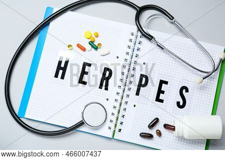 Notebook With Word Herpes, Different Pills And Stethoscope On Grey Background, Flat Lay