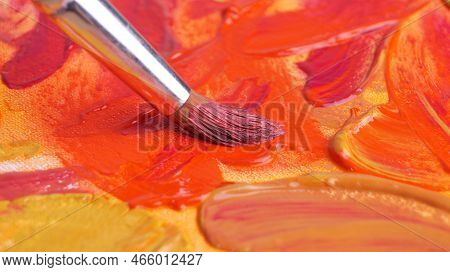 Brush On Artist's Palette With Mixed Paints, Closeup