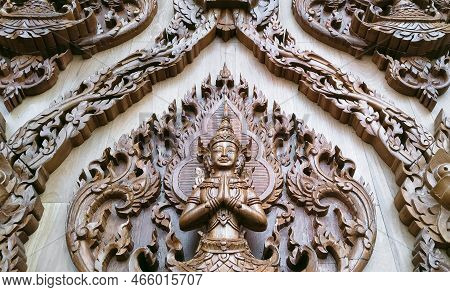 Low Angle View Of Wood Carving Deva Clasping Hand Pattern On Teak Wooden Wall Of Wat Krok Krak Templ