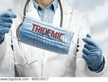 Tridemic Text On Face Mask In Doctors Hands In Public Space Or Hospital Background. Impersonal No Fa