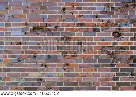 Background, Brick Wall Made Old German Red Burnt Brick With Traces Bullets And Shrapnel After World 