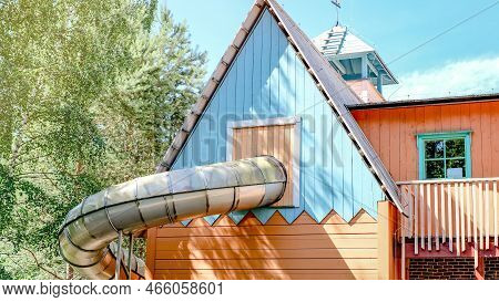 Childrens Slide In The Form Of A Pipe In An Amusement Park. Recreation And Entertainment Concept